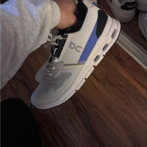 On Running White and Blue Athletic Shoes